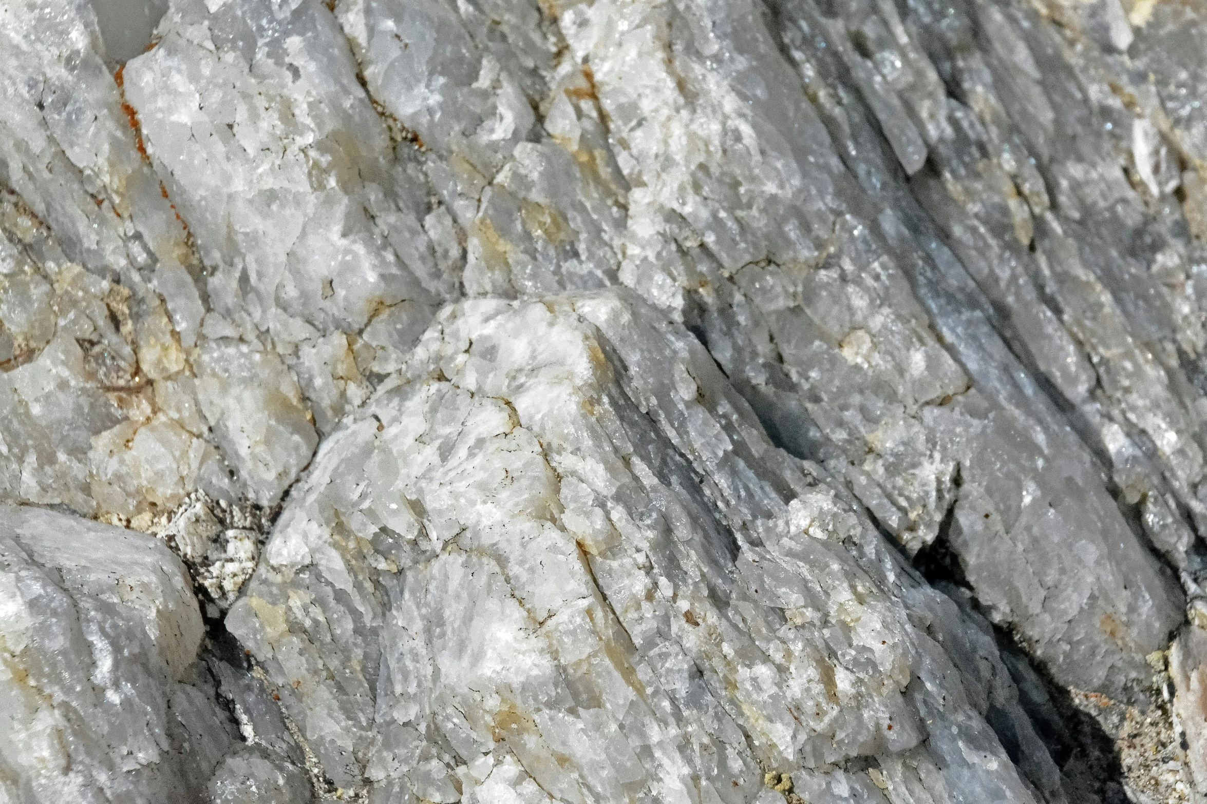 a rocky cliff is painted white and orange