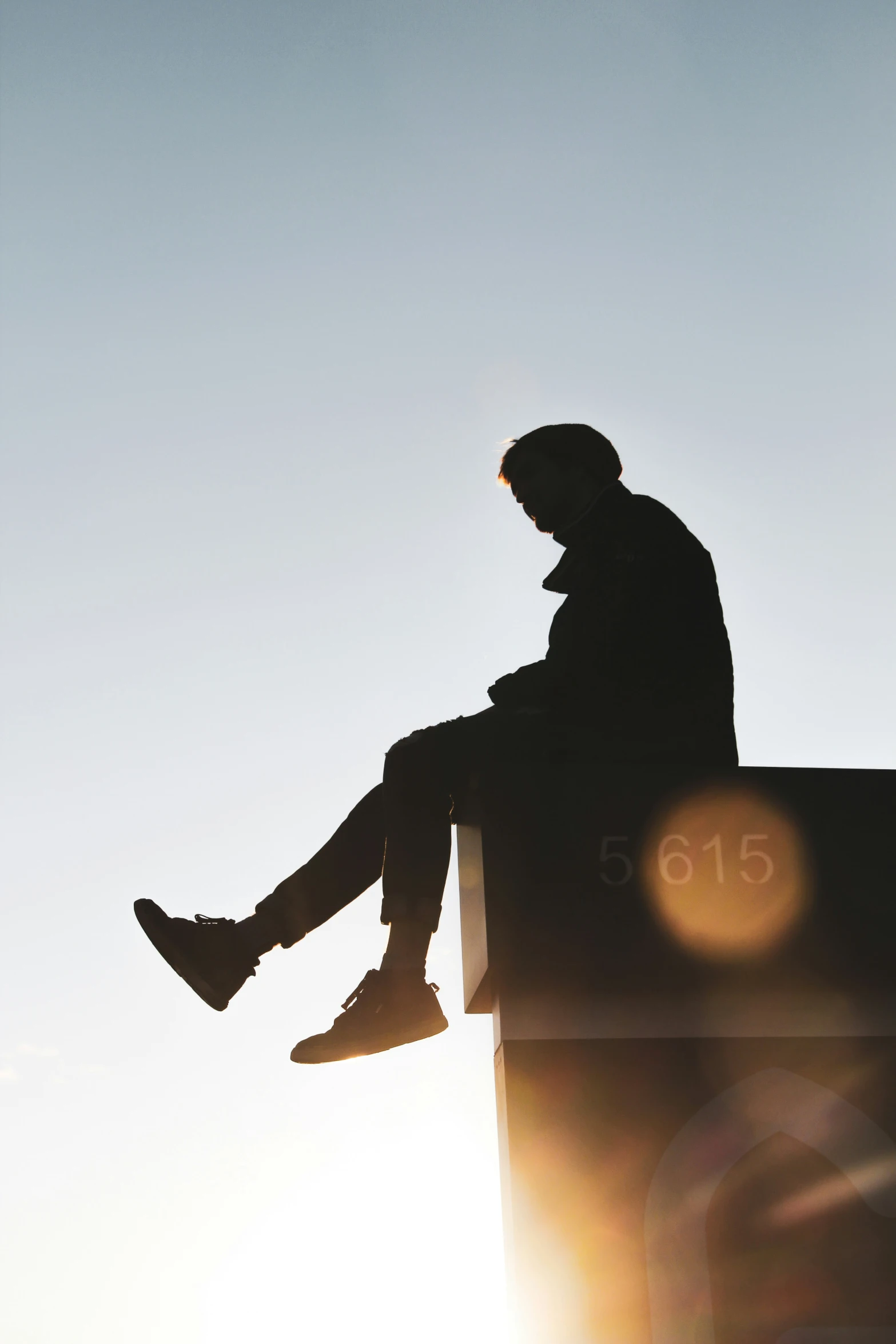 the man is sitting and waiting at sunrise or sunrise