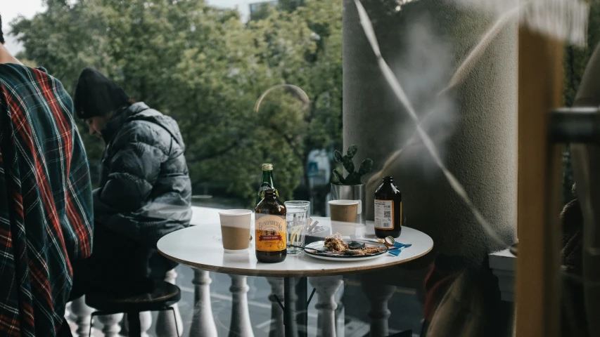 two people seated at a table with food and drinks