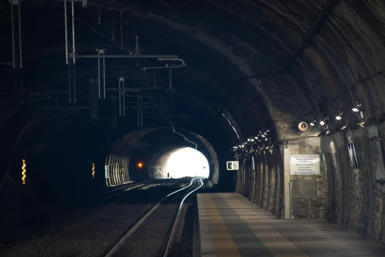 a large long tunnel with some lights on