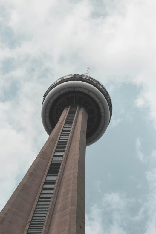 an air plane flies by the top of the tower