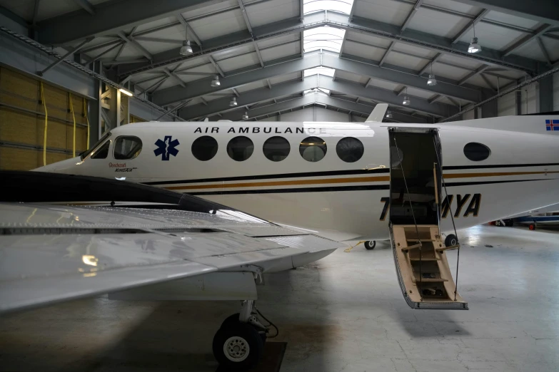 an airplane with several people on board sits inside a building