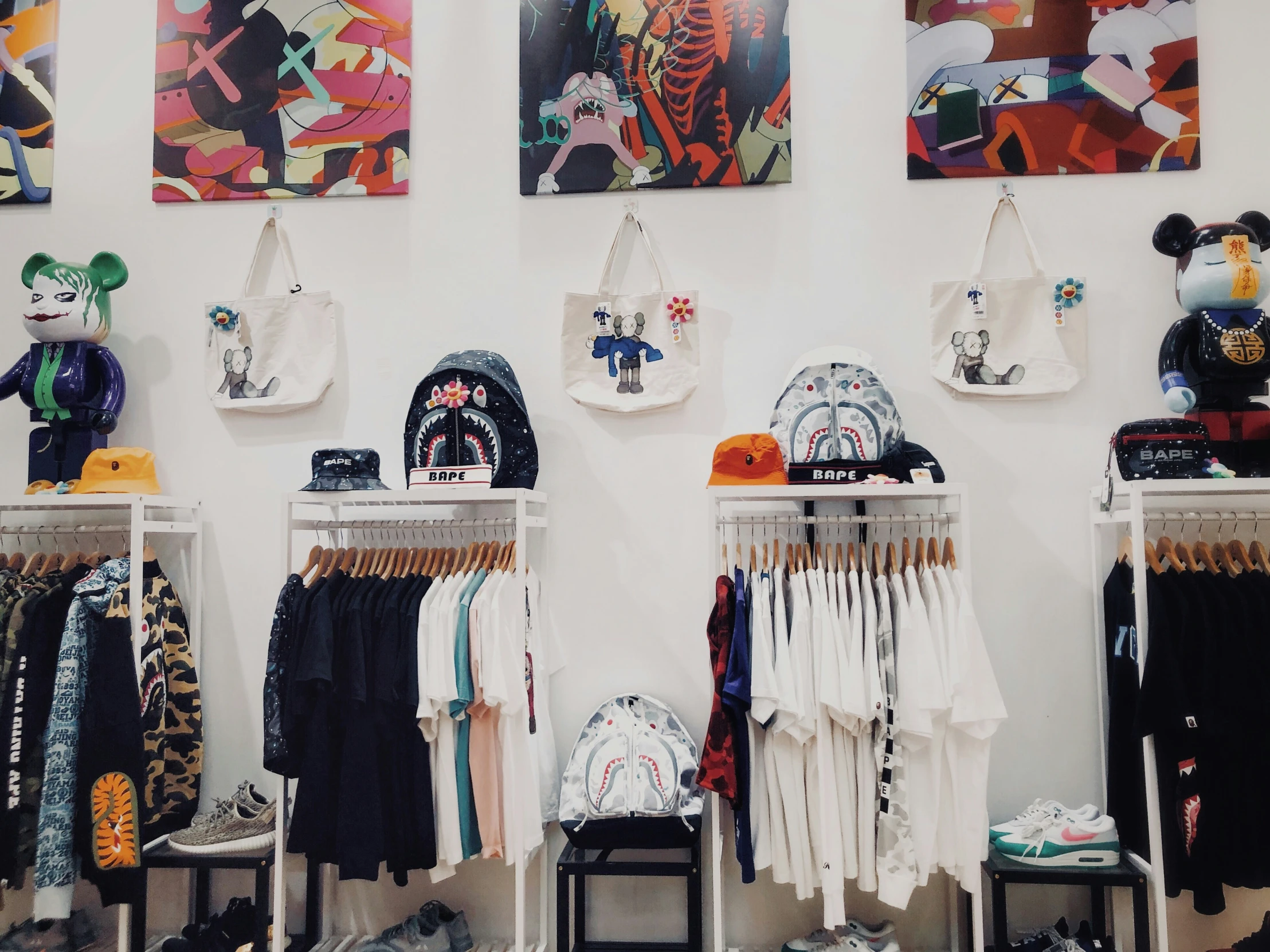 a room with two display racks full of children's clothing