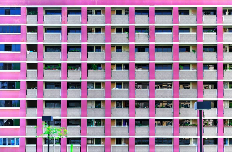 pink and gray building with a lot of windows