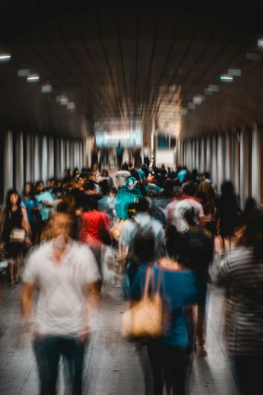 blurry po of people on sidewalk in an indoor area