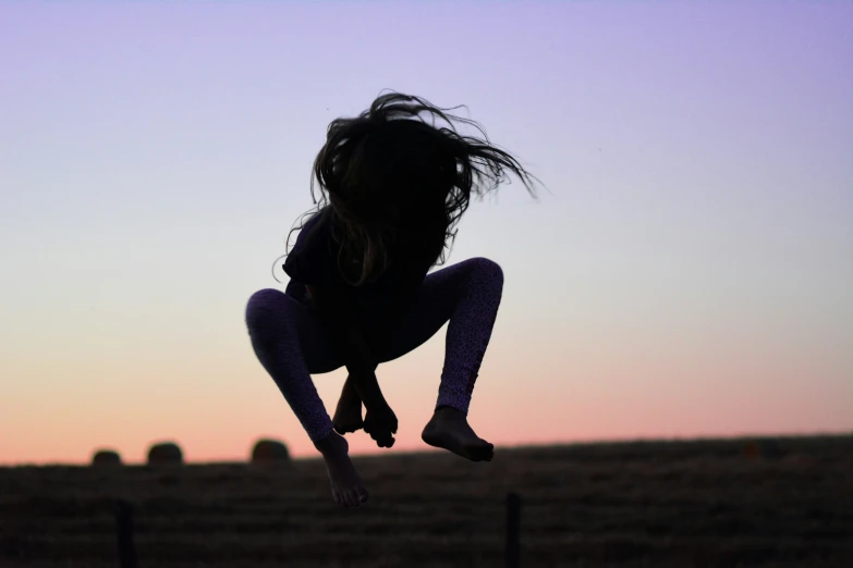 a person jumping into the air to catch a frisbee