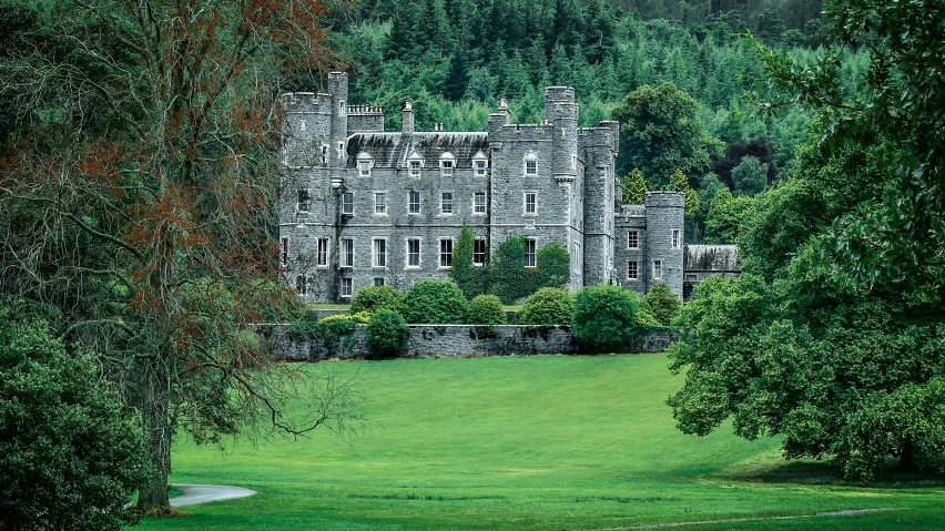 an old castle building nestled by some trees