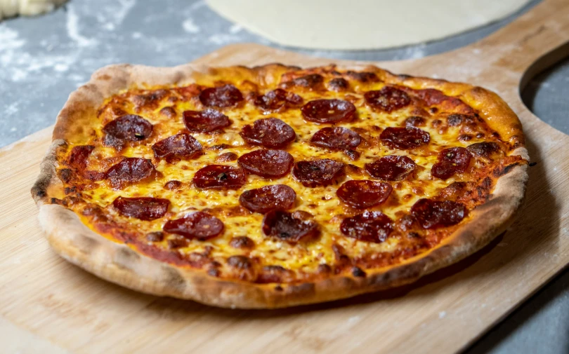 a large pizza on a wooden  board