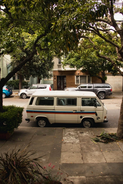 white van parked next to a sidewalk in the daytime