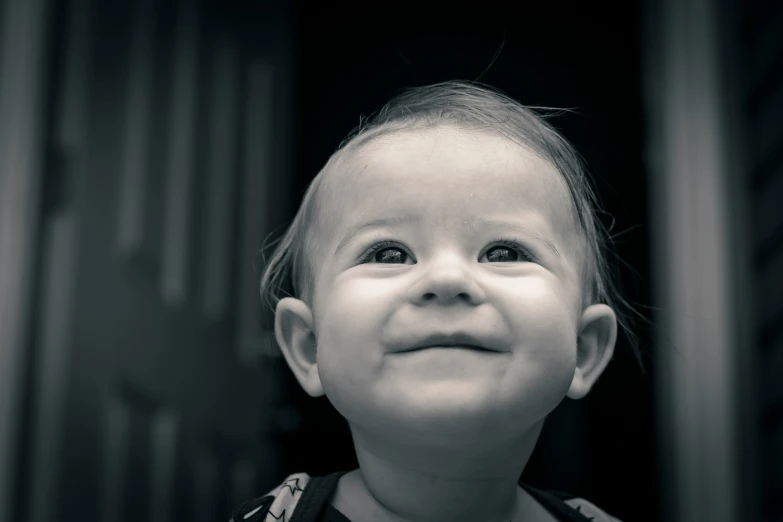 a smiling child looks into the camera