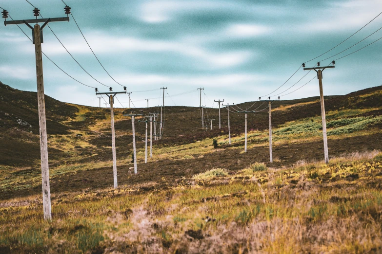 view of the mountains with power lines and telephone poles