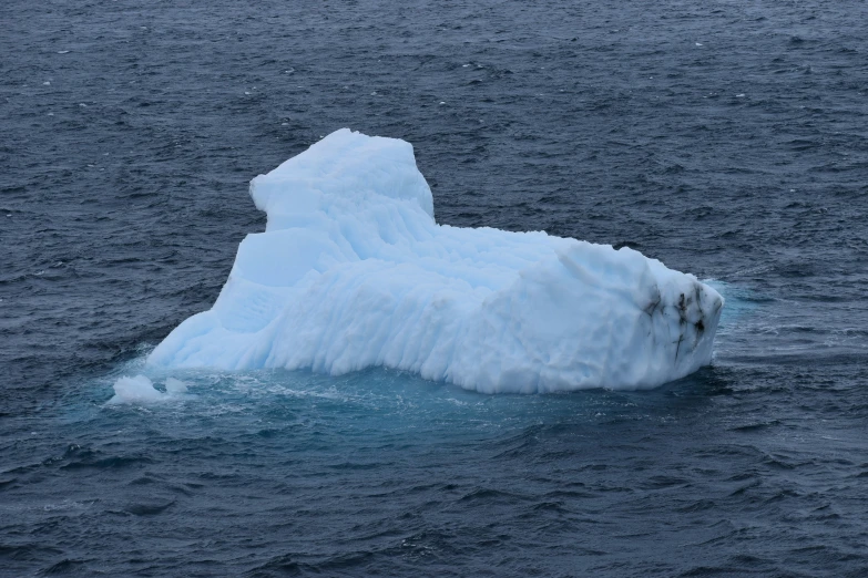 an iceberg floating on a large body of water