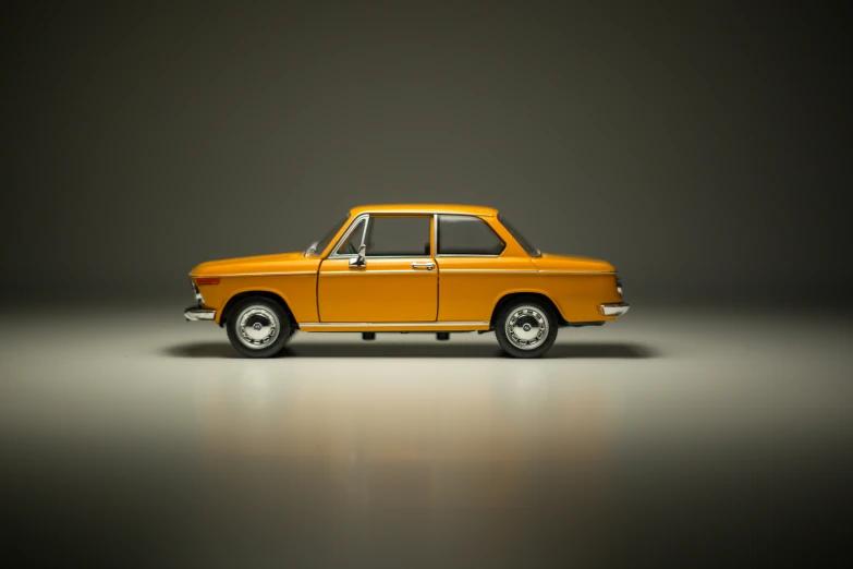 an orange car in a spotlight with a black background