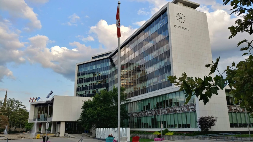 the flags are flying in the wind at an office building