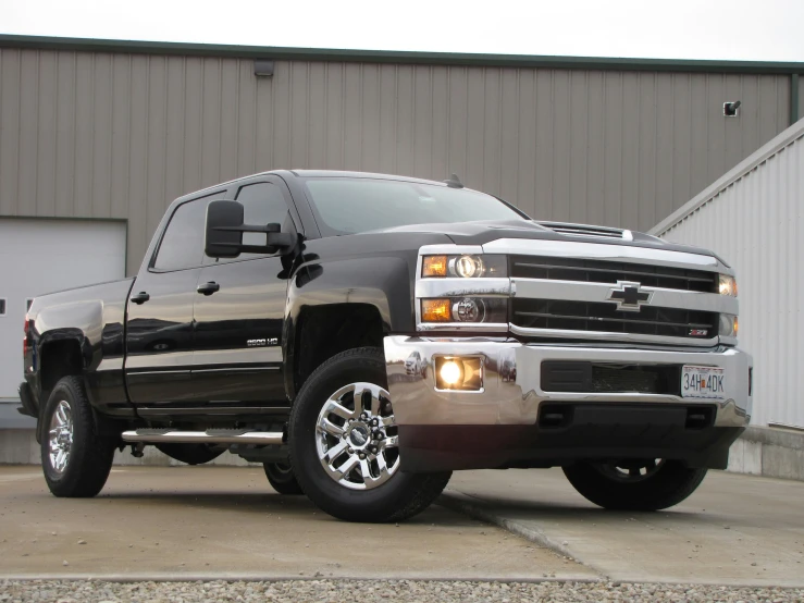 a silver truck parked next to a loading shed