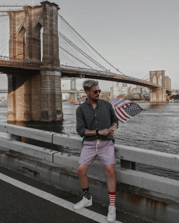 a man that is standing on the edge of a bridge