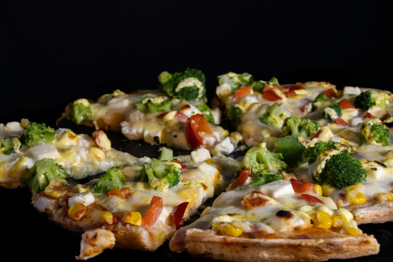 sliced pizza topped with broccoli and other ingredients