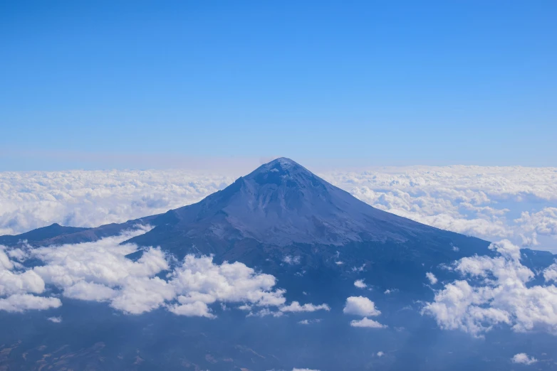 an image of a mountain top above the clouds