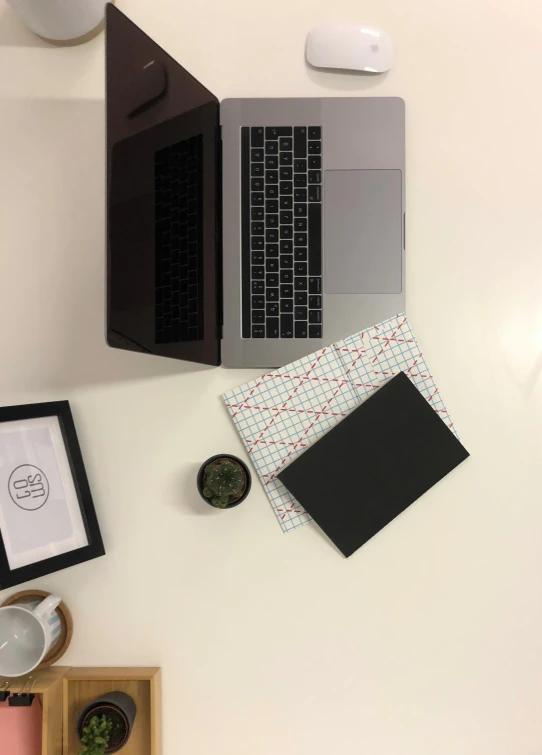 this table holds a laptop and two cups of coffee