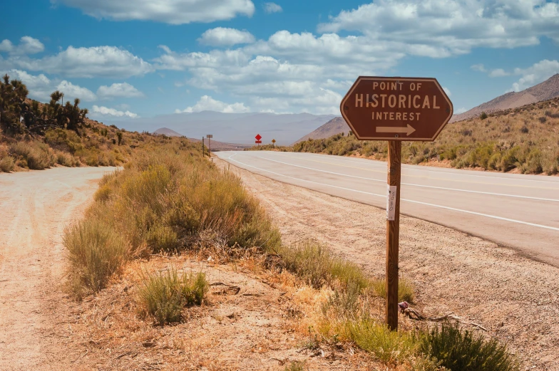 there is a wooden sign in the middle of nowhere