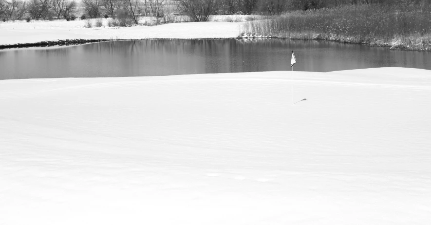 there is a small white flag in the snow by the lake