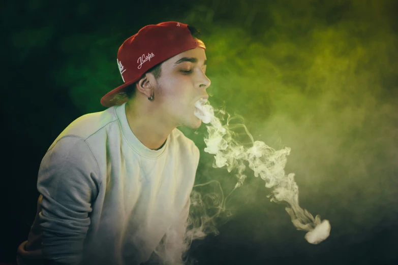 a  in a red hat smoking a cigarette