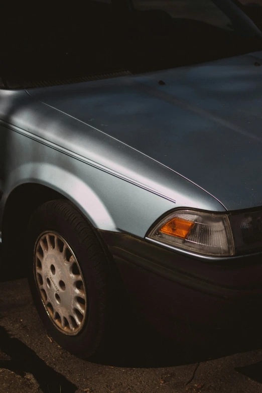 a blue sedan parked in a parking lot