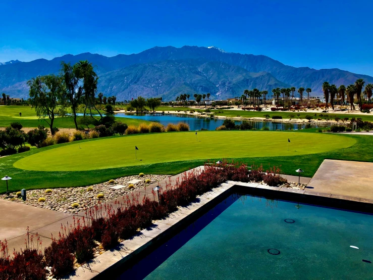 a golf course with a pond and grass