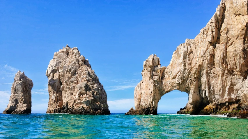 three rock formations sticking out of the water