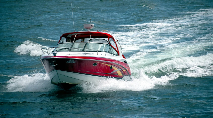 a man riding on top of a boat in the ocean