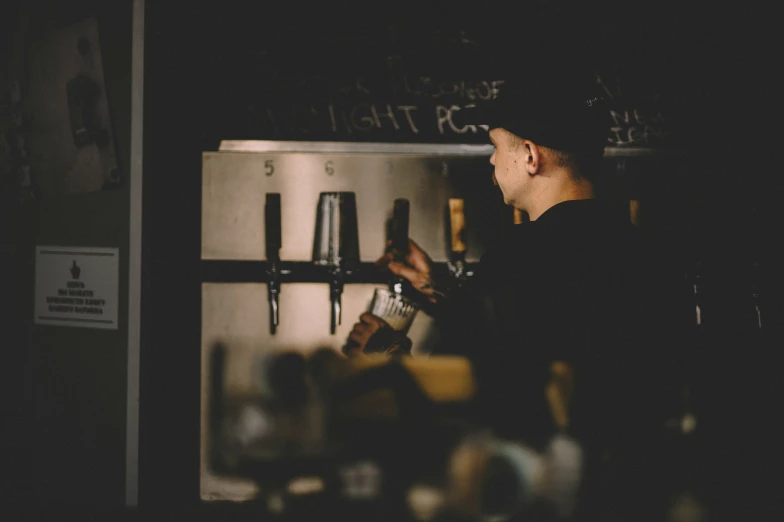 a man looking at the oven in the dark