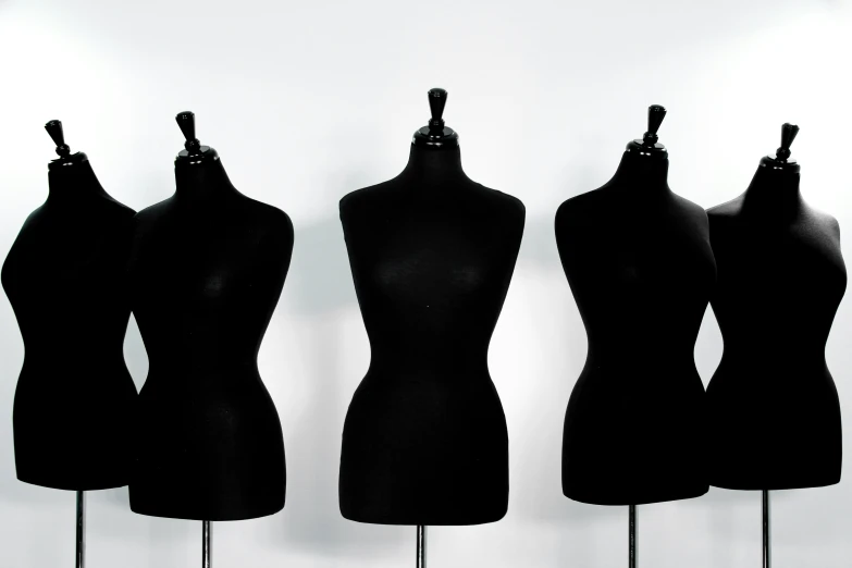 a group of mannequins standing on stand and posing for a picture