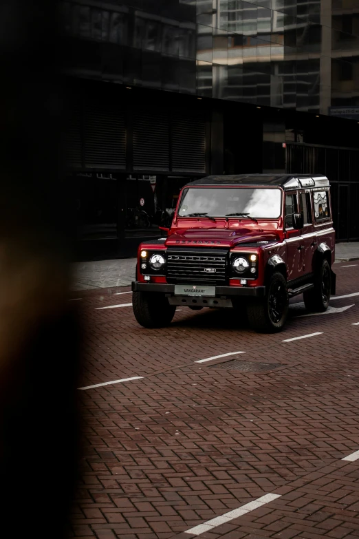 a red truck is stopped in the middle of a street