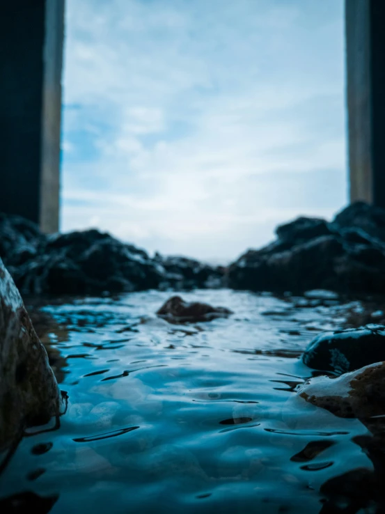 looking out at the ocean from the shore with a very high tide