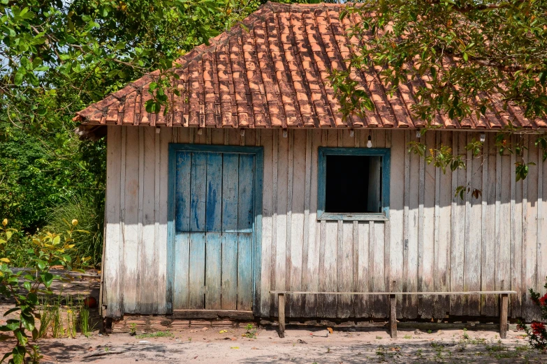 a small white and brown house with a red roof