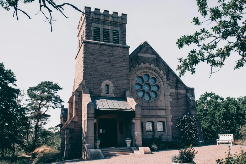 an old church sitting in the middle of a forest