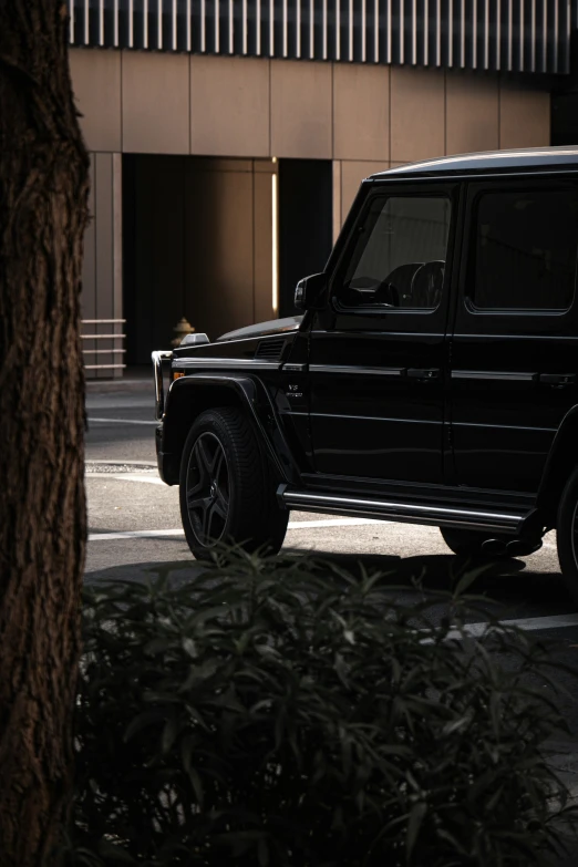 black mercedes g wagon parked in front of building