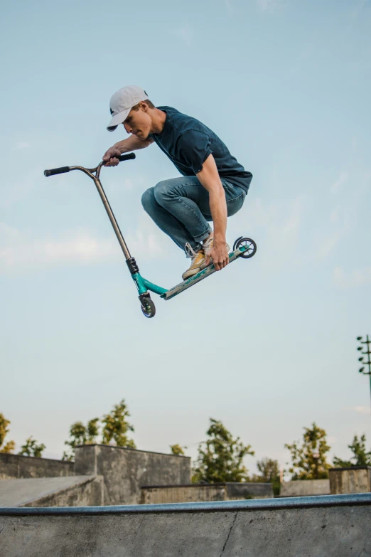 a skateboarder is in mid air after jumping his board