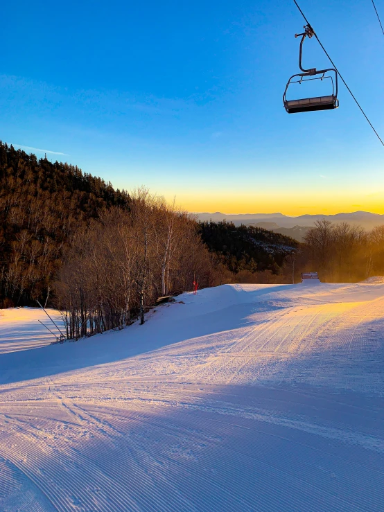 a person skis down the slopes at sunset