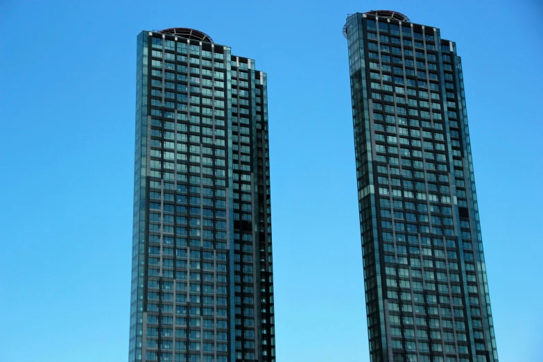 two very tall buildings sitting side by side