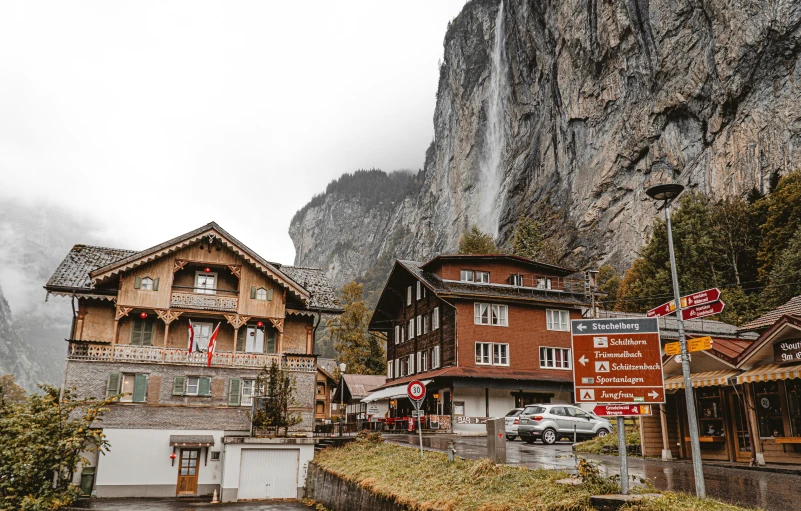 an area of mountainside with houses and parked cars