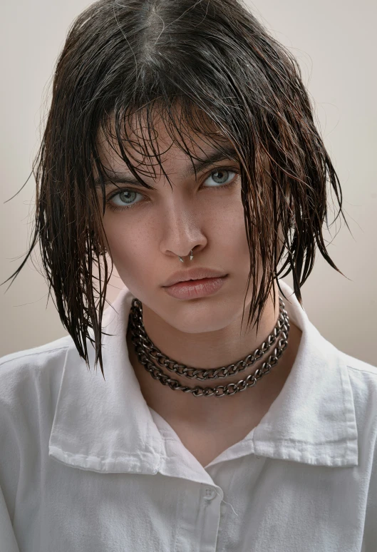 a woman with a collared shirt on a brown background