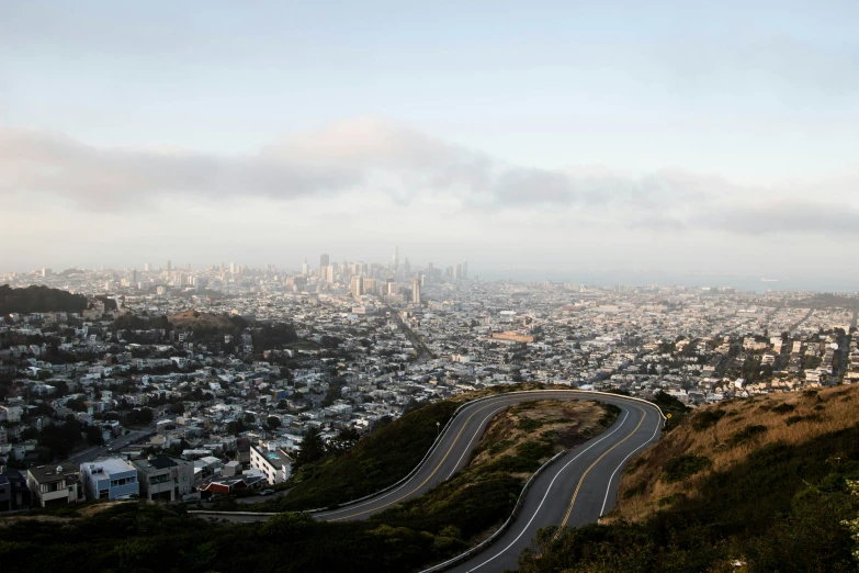 this city is on top of a hill with a curving road