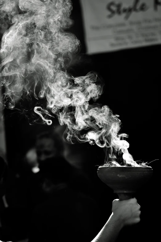 black and white pograph of a pot being used as fire pit