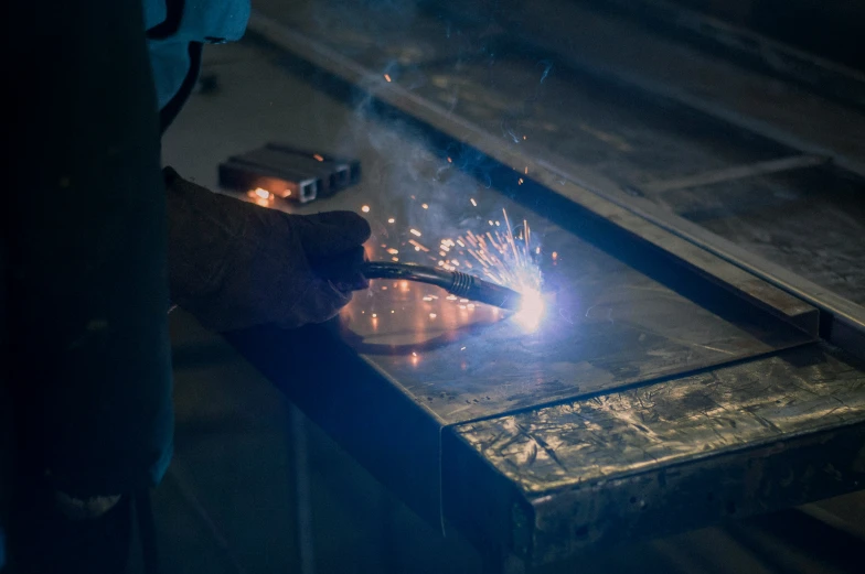 a person welding steel bars on a table