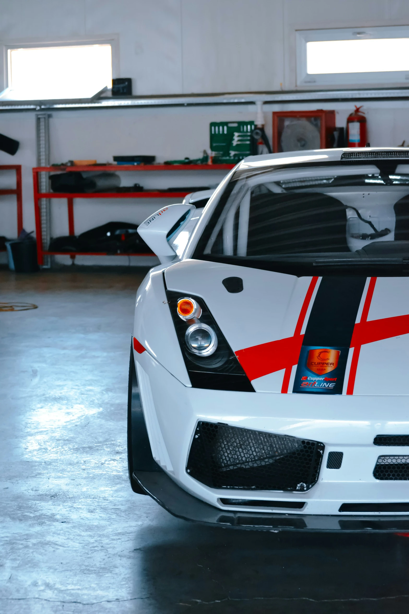 a white and black sports car parked in a garage