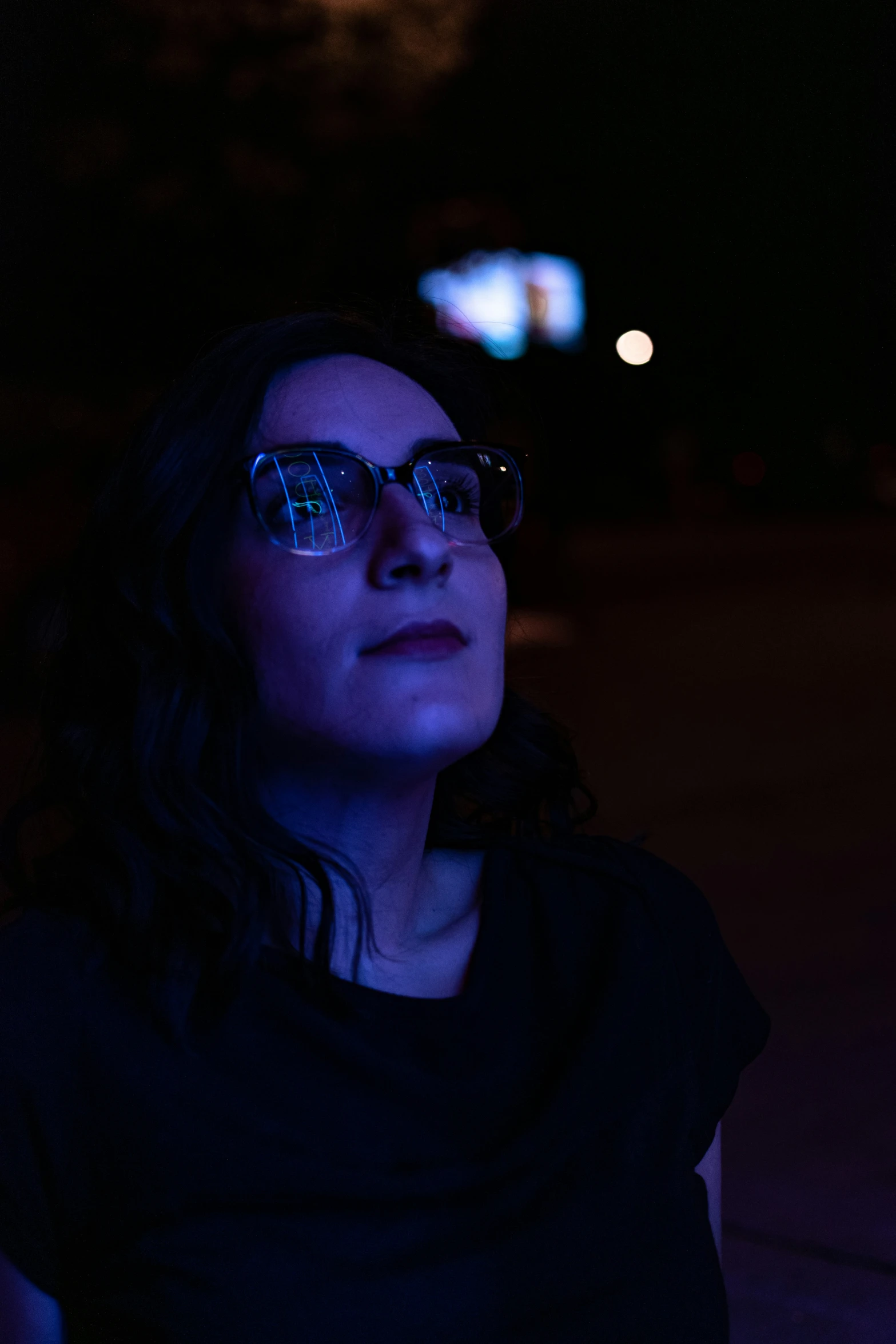 woman with glasses at night in the dark
