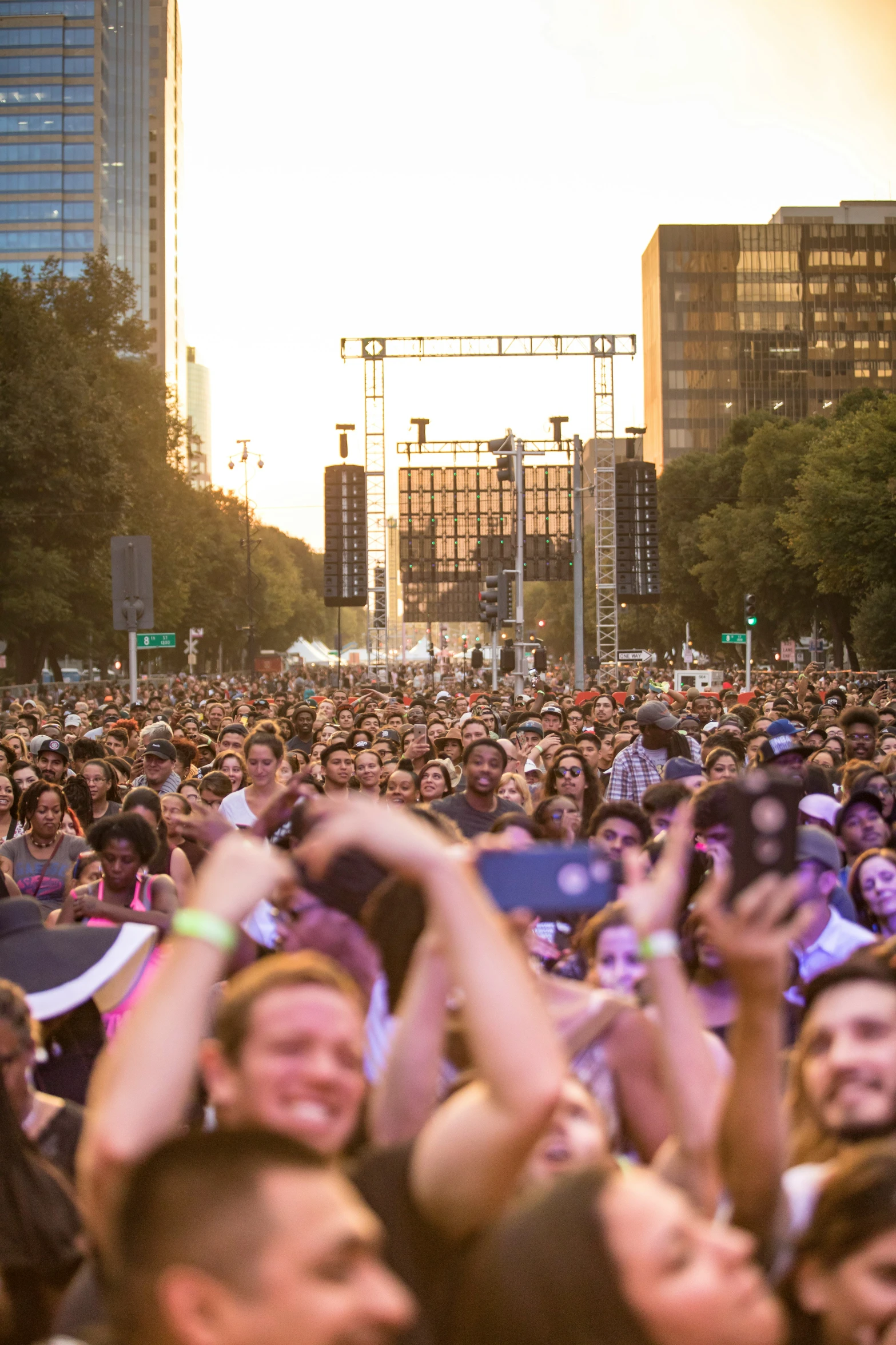 a large crowd of people are outside at sunset