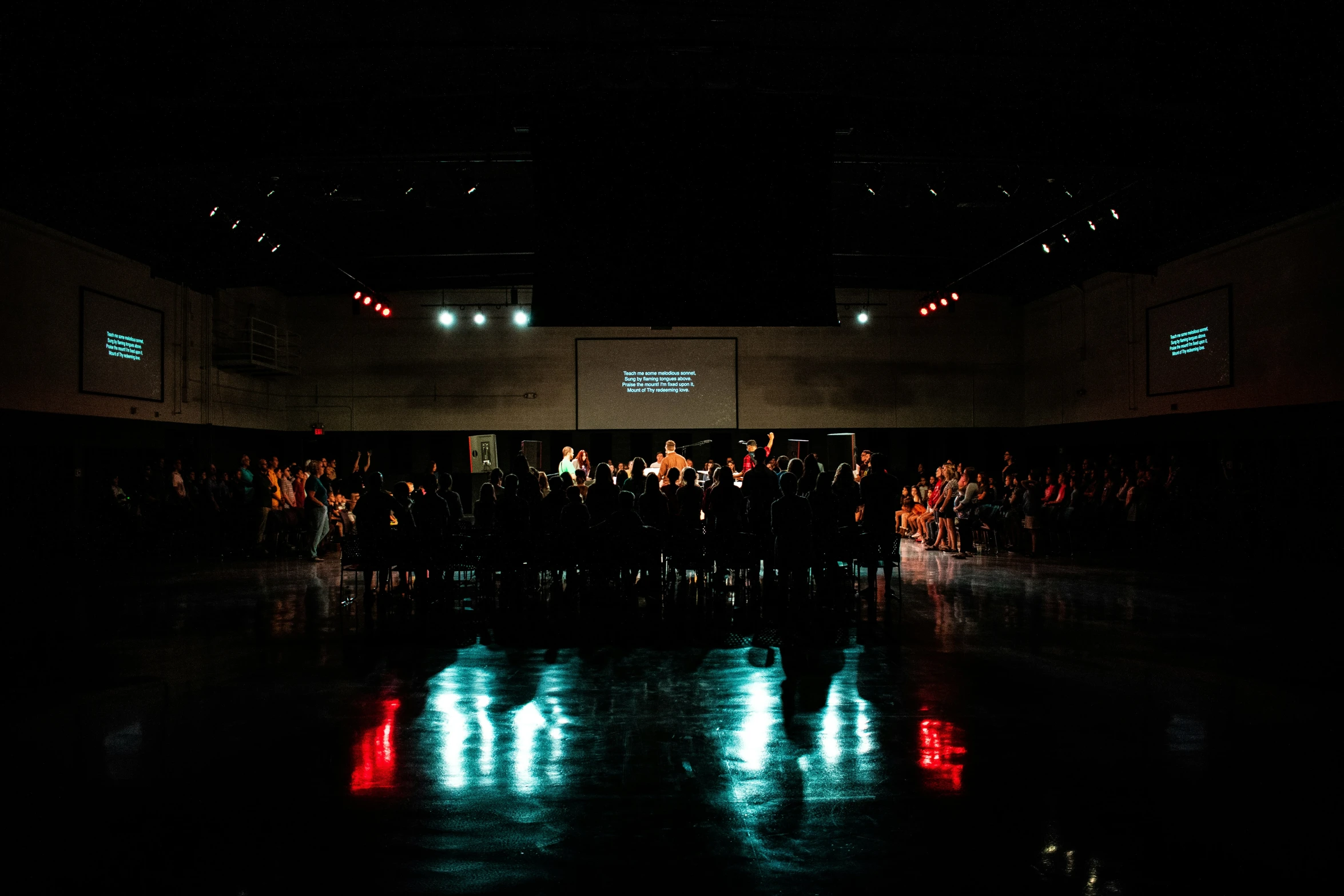 a dark room with lights reflected in the water