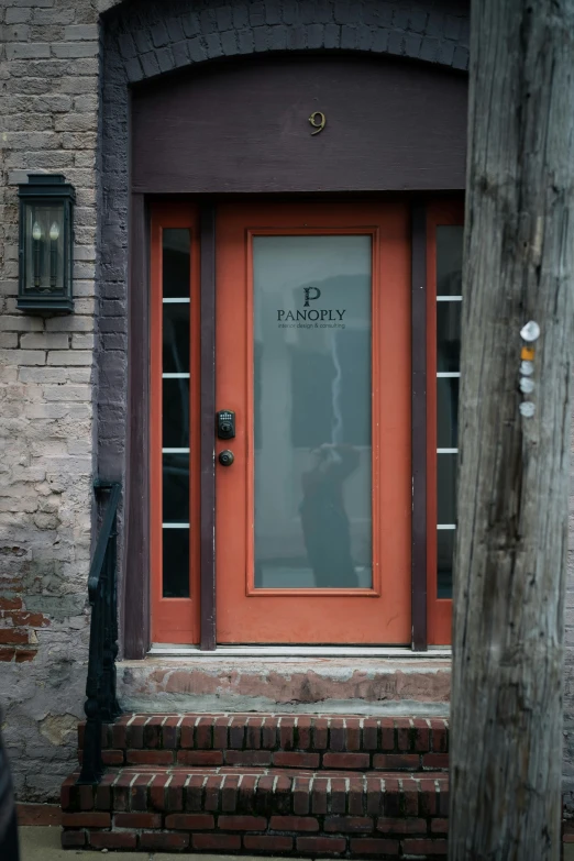 a door and stairs in front of a brick building